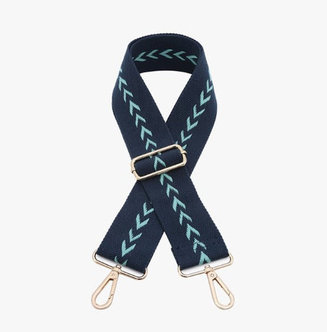 Navy blue strap with green pattern and gold hardware on a white background