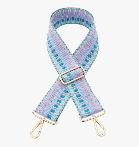 Multicolored woven bag strap with gold hardware on a white background