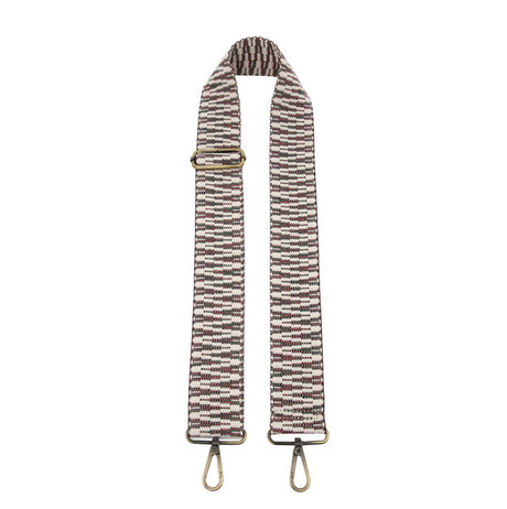 Striped bag strap with gold hardware on a white background