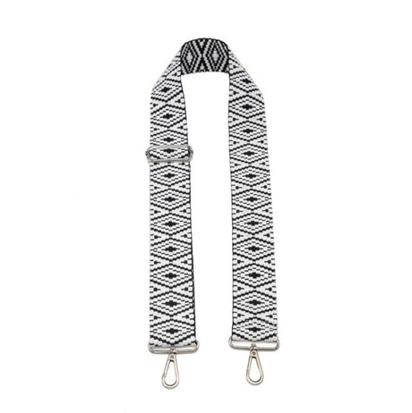 Black and white patterned bag strap with metal clasps on a white background