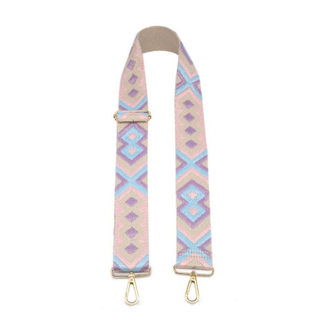 Patterned bag strap with gold hardware on a white background
