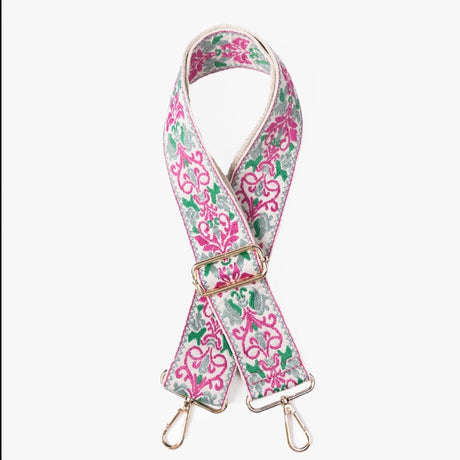 Floral patterned strap with gold hardware on a white background