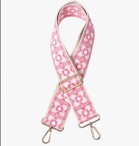 Pink and white patterned bag strap with gold hardware on a white background