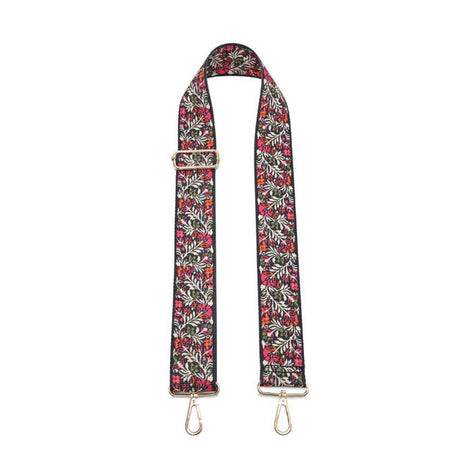 Floral patterned bag strap with metal hardware on a white background