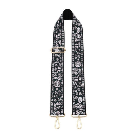 Black floral patterned bag strap with gold hardware on a white background