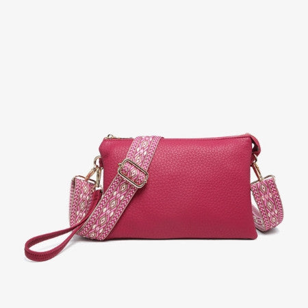 Pink handbag with a patterned strap on a white background