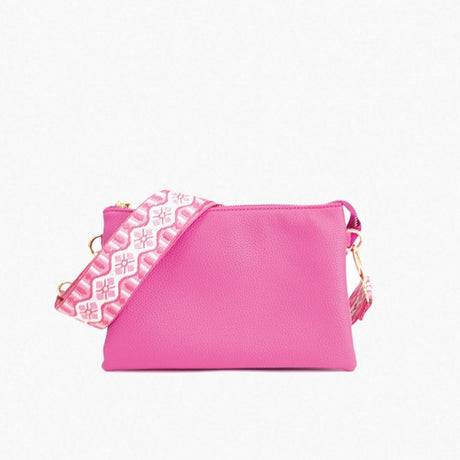 Pink handbag with a geometric patterned interior on a white background