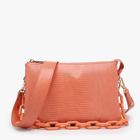 Coral handbag with chain detail on a white background