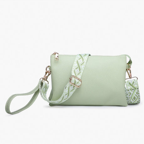 Pale lime handbag with a patterned strap on a white background