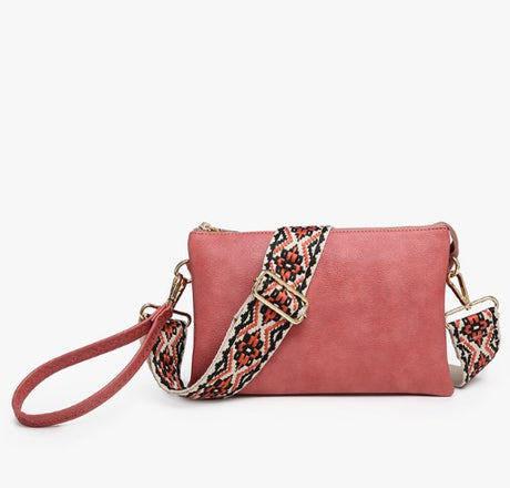 Pink handbag with a patterned strap on a white background