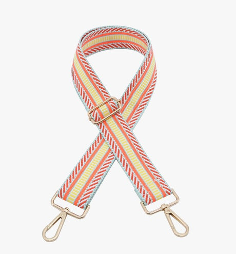 Striped bag strap with gold hardware on a white background