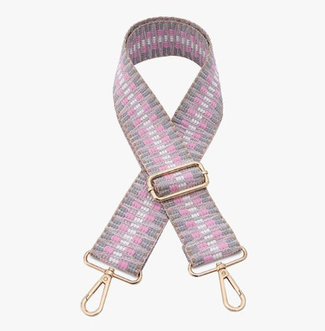 Woven bag strap with gold hardware on a white background