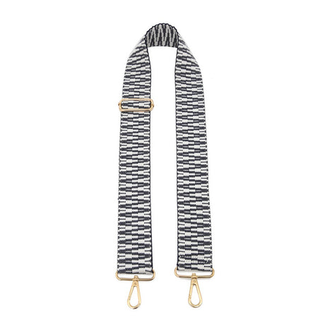 Black and white striped bag strap with gold hardware on a white background