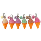 Six pastel-colored ice cream cone charms with donut-shaped clips, arranged in a row on a plain white background.