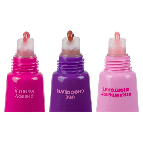 Three lip balm tubes in bright pink, purple, and light pink, shown side by side on a white background. The tubes are labeled Cherry Vanilla,UBE Chocolate, and Strawberry Shortcake respectively, and each has a small amount of balm visible at the tip.