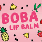 Pink square graphic with the words 'BOBA LIP BALM' in large pink letters, surrounded by illustrated fruit slices, strawberries, blackberries, and green leaves on a pink background.