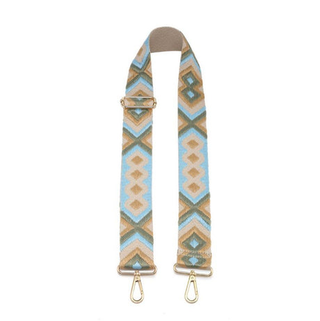 Patterned bag strap with gold hardware on a white background