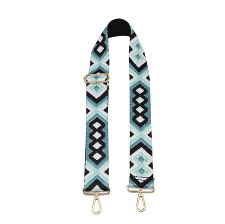 Patterned bag strap with gold hardware on a white background