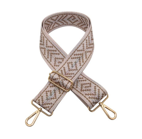 Patterned bag strap with gold hardware on a white background