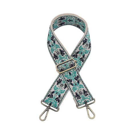 Floral patterned bag strap with metal hardware on a white background
