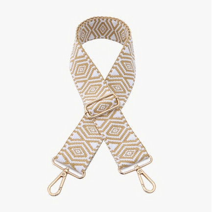 Patterned bag strap with gold hardware on a white background