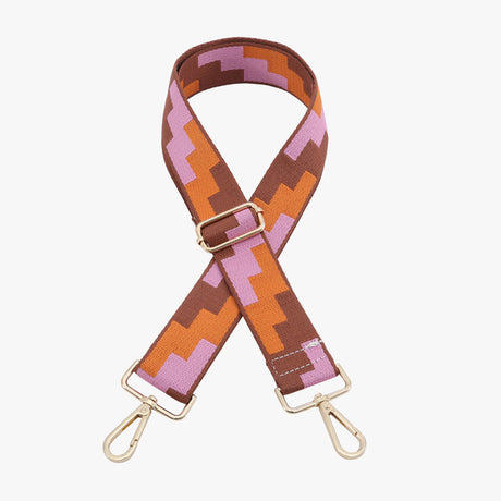 Patterned bag strap with gold hardware on a white background