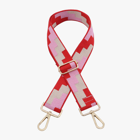 Red and pink patterned strap with gold hardware on a white background