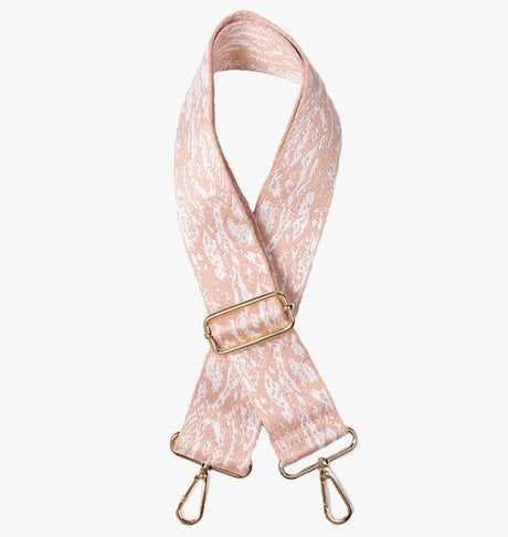 Pink lace bag strap with gold hardware on a white background