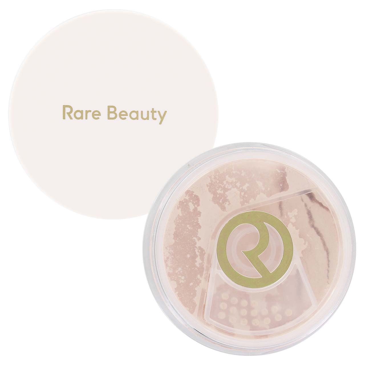 Rare Beauty loose setting powder in a clear round compact with the cream-colored lid placed behind it on a white background.