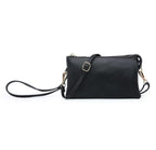 Black vegan leather crossbody bag with a strap on a white background