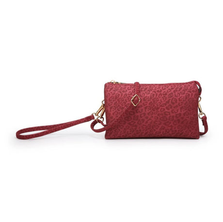 Red cheetah print handbag with a strap on a white background