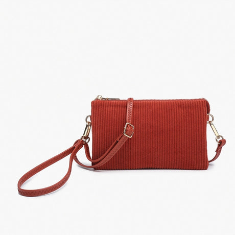 Red corduroy handbag with a strap on a white background