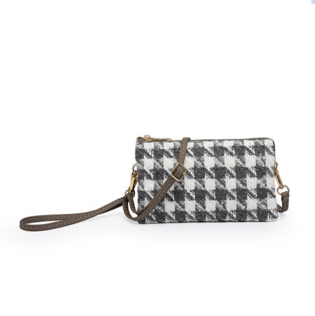 Houndstooth patterned handbag with brown strap on a white background