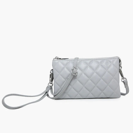 Quilted grey handbag with a strap on a white background