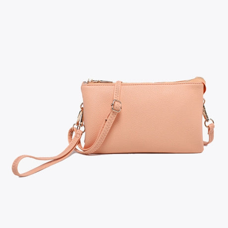 Riley Sherbert crossbody bag on a light gray background