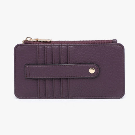 A dark purple pebbled leather zip-around wallet with a front strap closure and gold-tone hardware, shown against a plain white background.