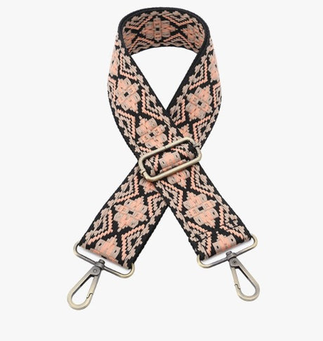 Floral patterned bag strap with metal hardware on a white background