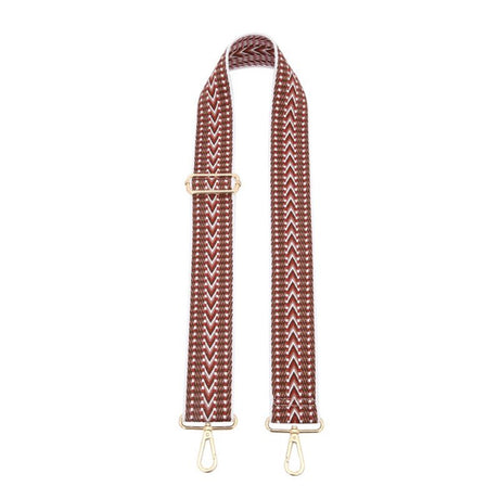 Woven bag strap with gold hardware on a white background