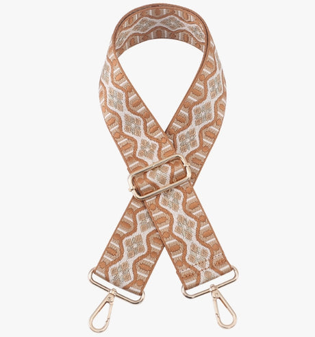 Patterned bag strap with gold hardware on a white background